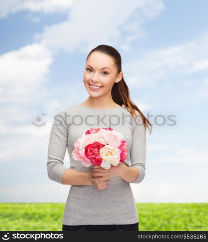 holidays, love and flowers concept - young woman with bouquet of flowers