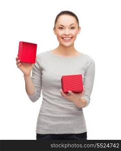 holidays, love and happiness concept - beautiful girl opening red gift box