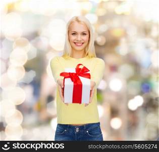 holidays, love and happiness concept - beautiful girl with gift box
