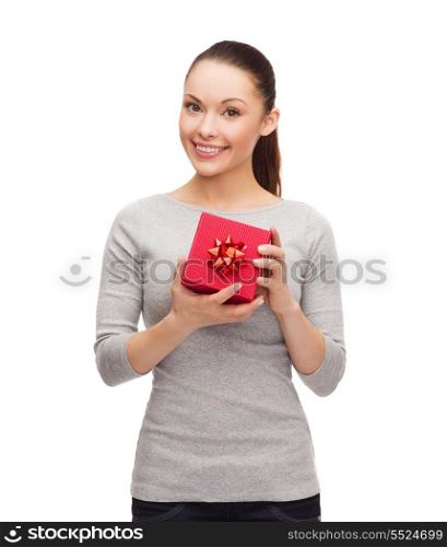 holidays, love and happiness concept - beautiful girl with red gift box