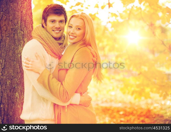 holidays, love, travel, tourism, relationship and dating concept - romantic couple in the autumn park