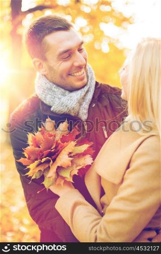 holidays, love, travel, tourism, relationship and dating concept - romantic couple in the autumn park