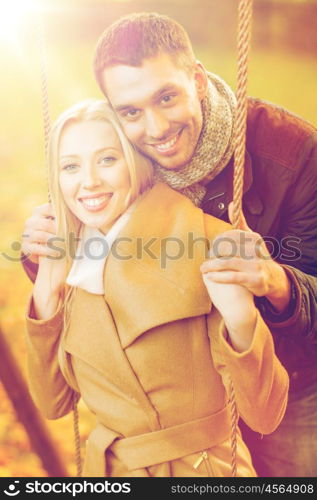 holidays, love, travel, tourism, relationship and dating concept - romantic couple in the autumn park