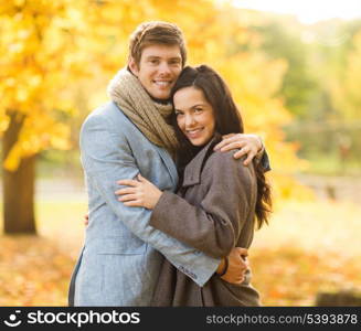 holidays, love, travel, tourism, relationship and dating concept - romantic couple in the autumn park