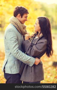 holidays, love, travel, tourism, relationship and dating concept - romantic couple in the autumn park