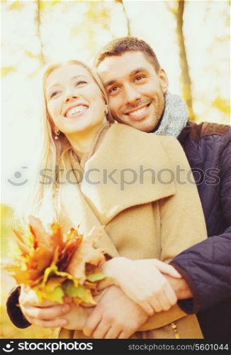 holidays, love, travel, tourism, relationship and dating concept - romantic couple in the autumn park