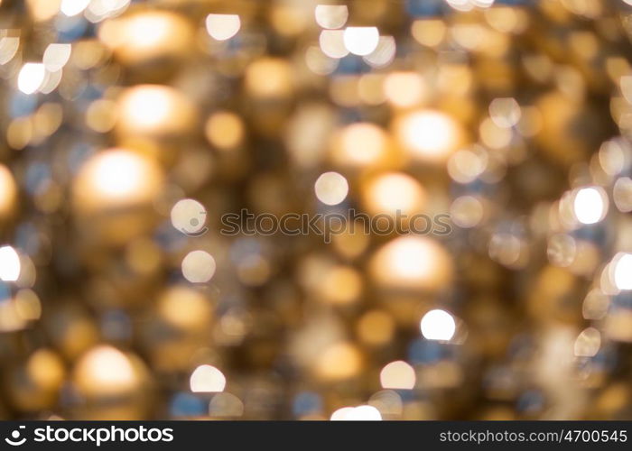 holidays, luxury and background concept - blurred golden christmas decoration or garland lights bokeh