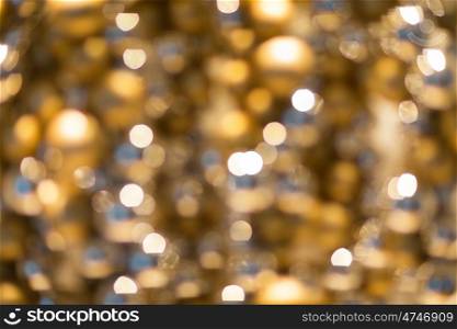 holidays, luxury and background concept - blurred golden christmas decoration or garland lights bokeh