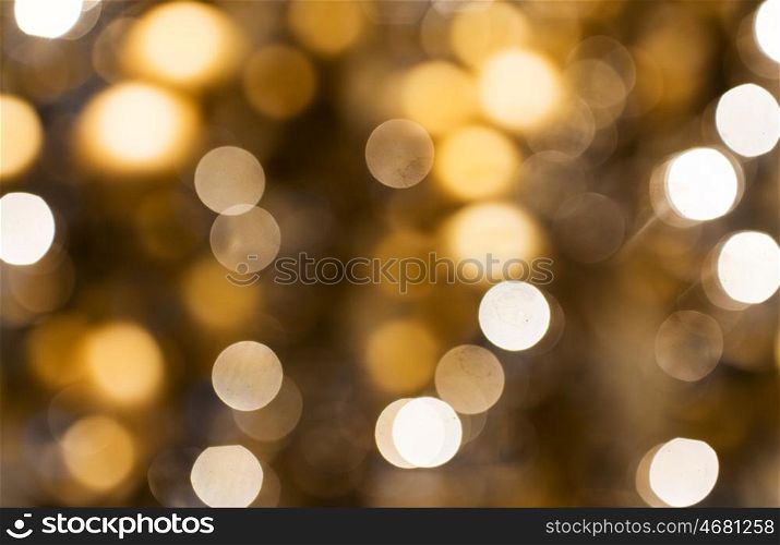 holidays, luxury and background concept - blurred golden christmas lights bokeh