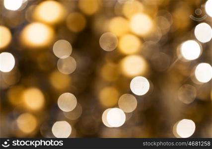 holidays, luxury and background concept - blurred golden christmas lights bokeh
