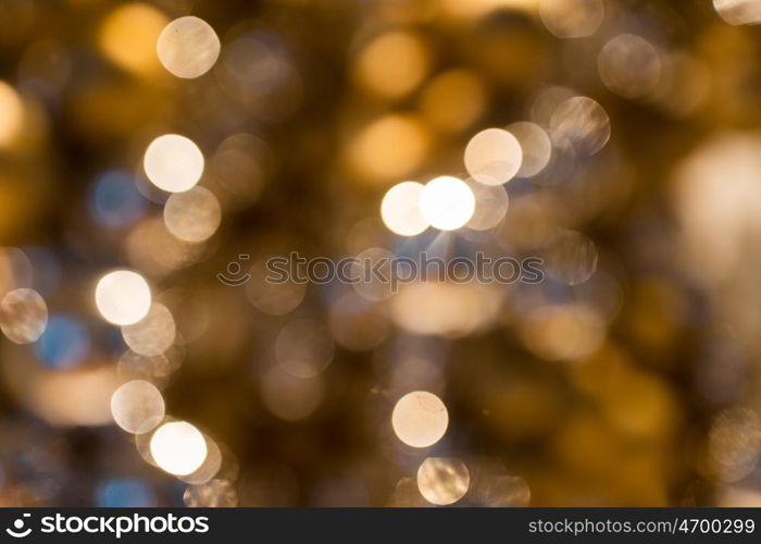 holidays, luxury and background concept - blurred golden christmas lights bokeh