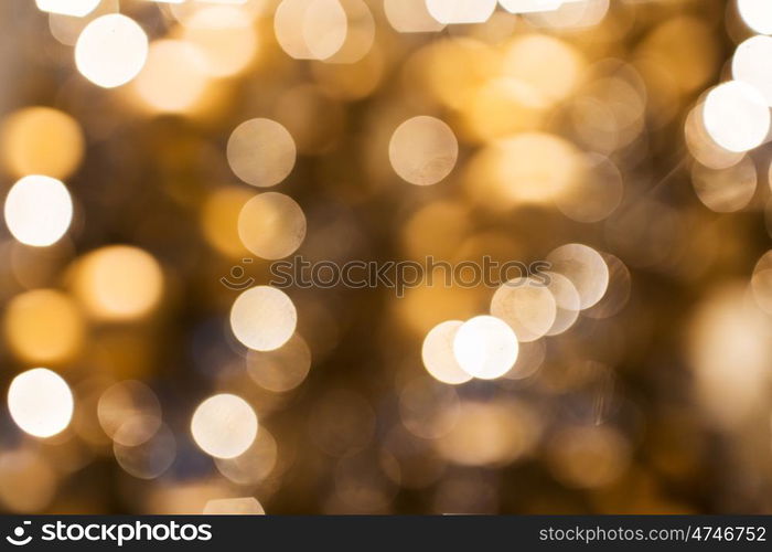 holidays, luxury and background concept - blurred golden christmas lights bokeh