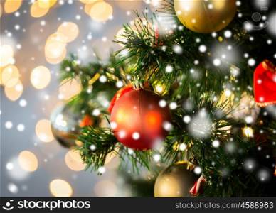holidays, new year, decor and celebration concept - close up of christmas tree decorated with balls