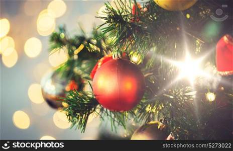 holidays, new year, decor and celebration concept - close up of christmas tree decorated with balls. close up of christmas tree decorated with balls