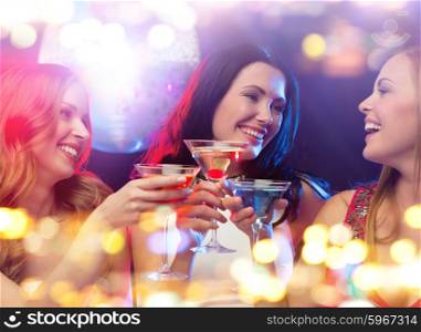 holidays, nightlife, bachelorette party and people concept - smiling women with cocktails at night club