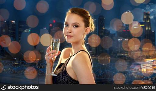holidays, nightlife, drinks, people and luxury concept - beautiful young asian smiling woman drinking champagne at party over singapore city night lights background
