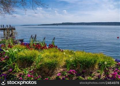 Holidays on beautiful Lake Constance with colorful flowers on the lake shore and sunshine