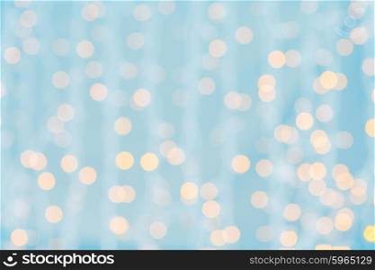 holidays, party and celebration concept - blurred blue and golden background with bokeh lights