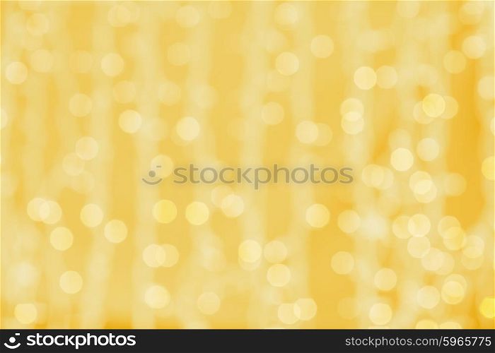 holidays, party and celebration concept - blurred golden background with bokeh lights