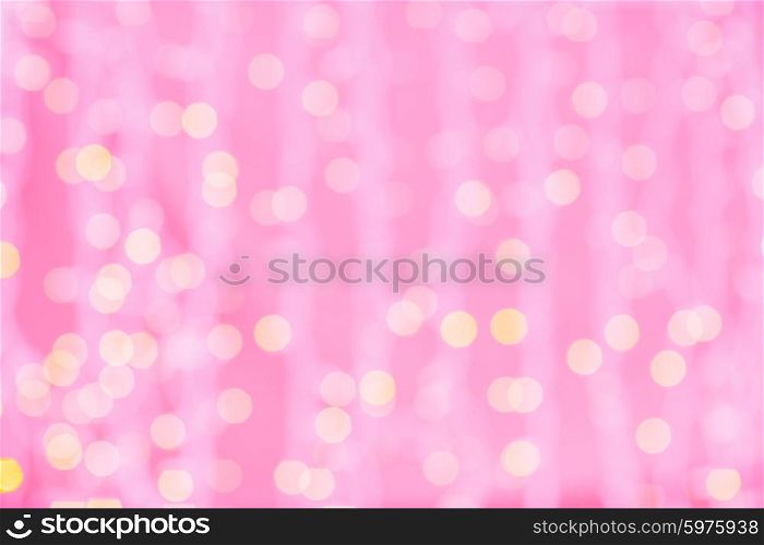 holidays, party and celebration concept - blurred pink and golden background with bokeh lights