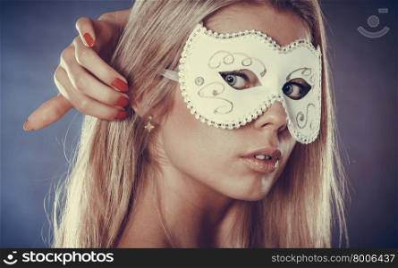Holidays, people and celebration concept. Closeup woman face caucasian blonde girl with white carnival mask