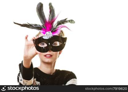 Holidays, people and celebration concept. Woman having fun trying carnival venetian mask on white background