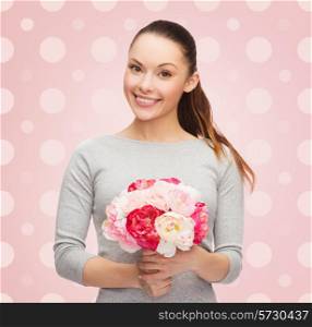 holidays, people and happiness concept - smiling young woman with flower over pink and white polka dots pattern background