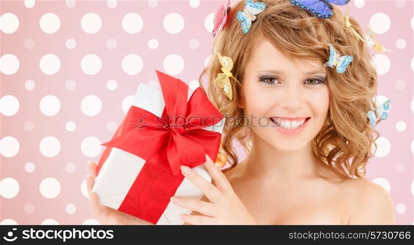 holidays, people and happiness concept - smiling young woman with flowers over pink and white polka dots pattern background