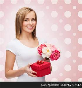 holidays, people and happiness concept - smiling young woman with gift box and flowers over pink white polka dots pattern background