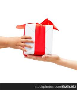 holidays, present, christmas, childhood and happiness concept - close up of child and mother hands with gift box
