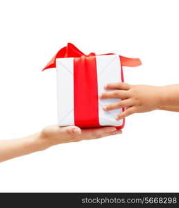 holidays, present, christmas, childhood and happiness concept - close up of child and mother hands with gift box