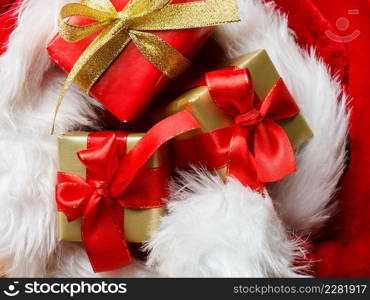 Holidays, present, christmas concept. Small boxes with gifts tied bows on red background