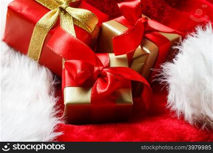 Holidays, present, christmas concept. Small boxes with gifts tied bows on red background