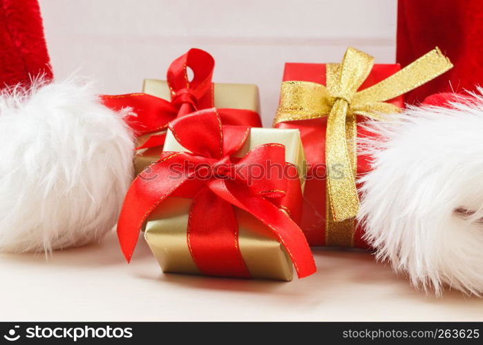 Holidays, present, christmas concept. Small red and golden boxes with gifts tied bows