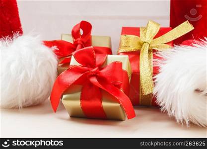 Holidays, present, christmas concept. Small red and golden boxes with gifts tied bows