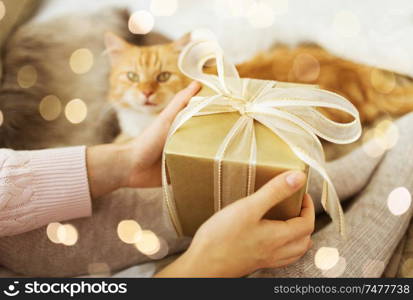 holidays, presents and people concept - close up of female hands holding christmas gift. close up of female hands holding christmas gift