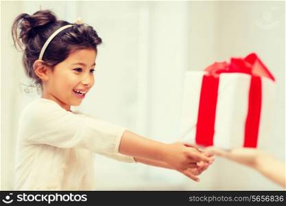 holidays, presents, christmas, birthday concept - happy child girl with gift box