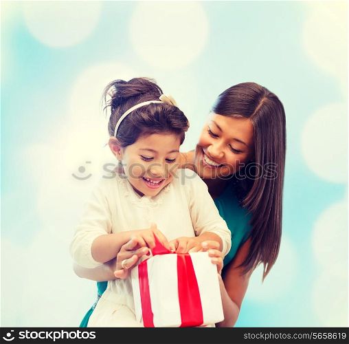 holidays, presents, christmas, birthday concept - happy mother and child girl with gift box