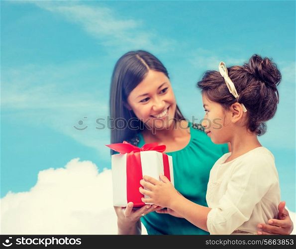 holidays, presents, christmas, birthday concept - happy mother and child girl with gift box