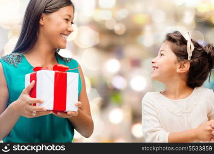 holidays, presents, christmas, family, child and x-mas concept - happy mother and child girl with gift box