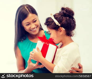 holidays, presents, christmas, x-mas and birthday concept - happy mother and child girl with gift box