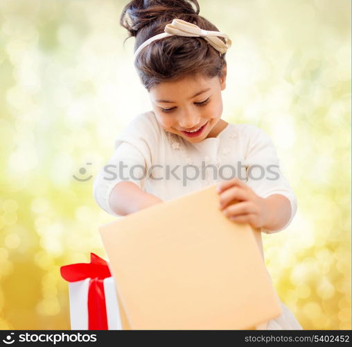 holidays, presents, christmas, x-mas, birthday concept - happy child girl with gift box