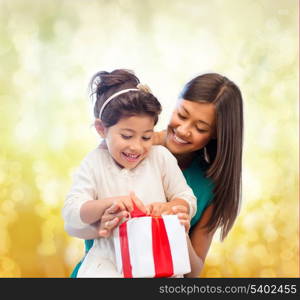 holidays, presents, christmas, x-mas, birthday concept - happy mother and child girl with gift box