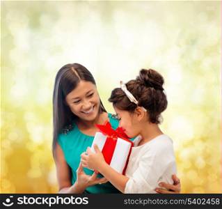 holidays, presents, christmas, x-mas, birthday concept - happy mother and child girl with gift box