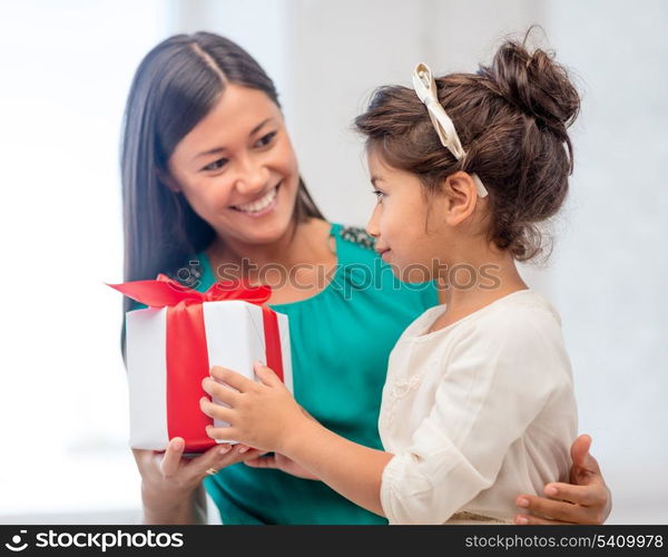 holidays, presents, christmas, x-mas, birthday concept - happy mother and child girl with gift box