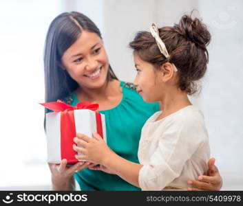 holidays, presents, christmas, x-mas, birthday concept - happy mother and child girl with gift box