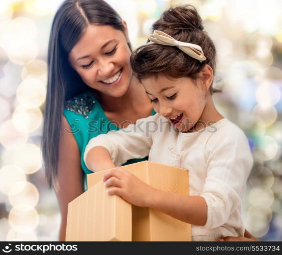 holidays, presents, christmas, x-mas, birthday concept - happy mother and child girl with gift box