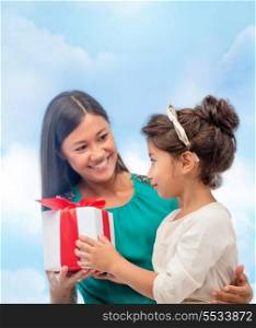 holidays, presents, christmas, x-mas, birthday concept - happy mother and child girl with gift box
