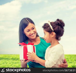 holidays, presents, christmas, x-mas, birthday concept - happy mother and child girl with gift box