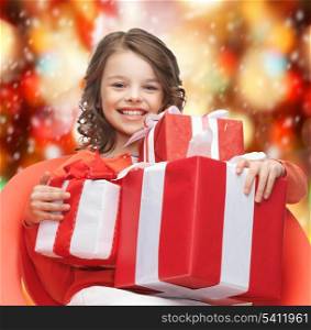 holidays, presents, christmas, x-mas concept - happy child girl with gift boxes